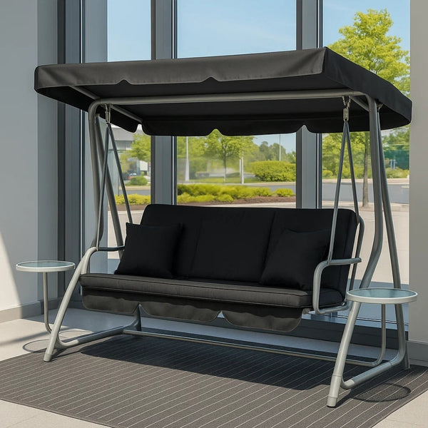 A dark grey three-seater swing chair with side tables, designed for outdoor furniture use, displayed indoors for visibility.